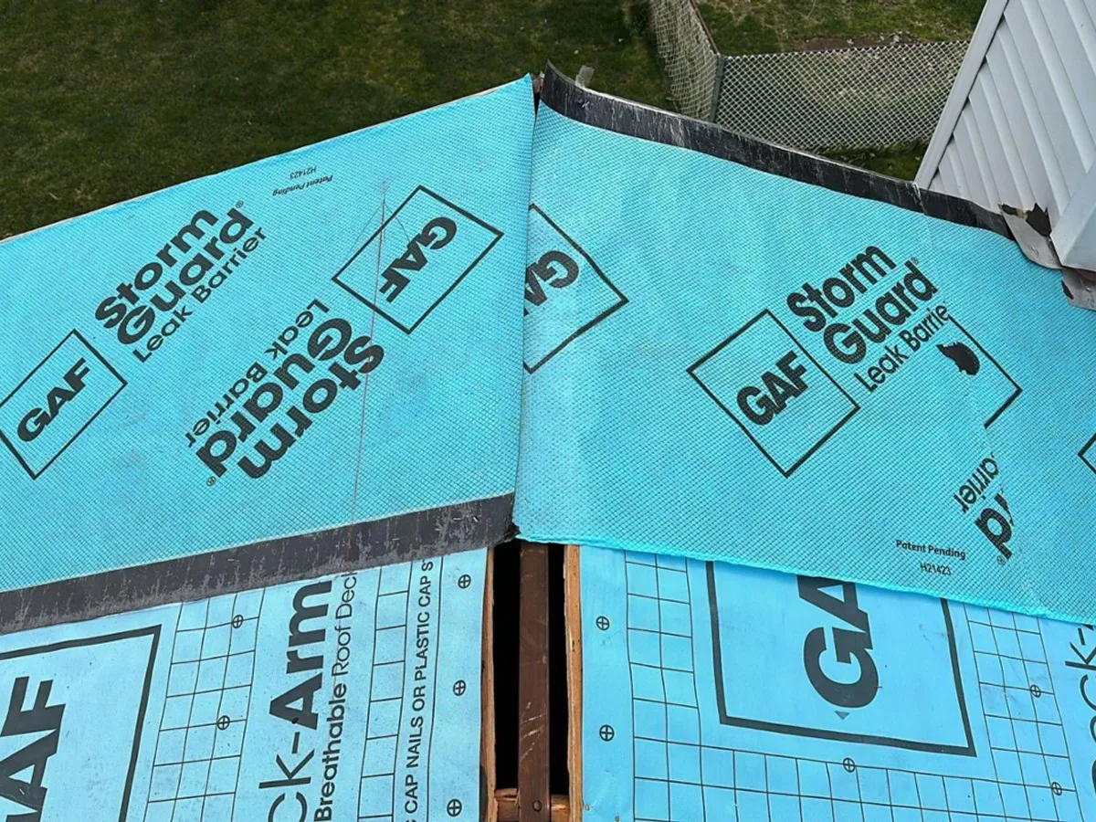 Roof replacement in progress showing synthetic underlayment