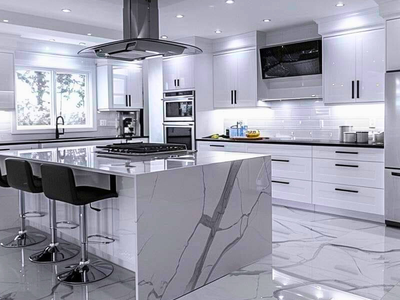 Renovated kitchen with stone counters and tile work